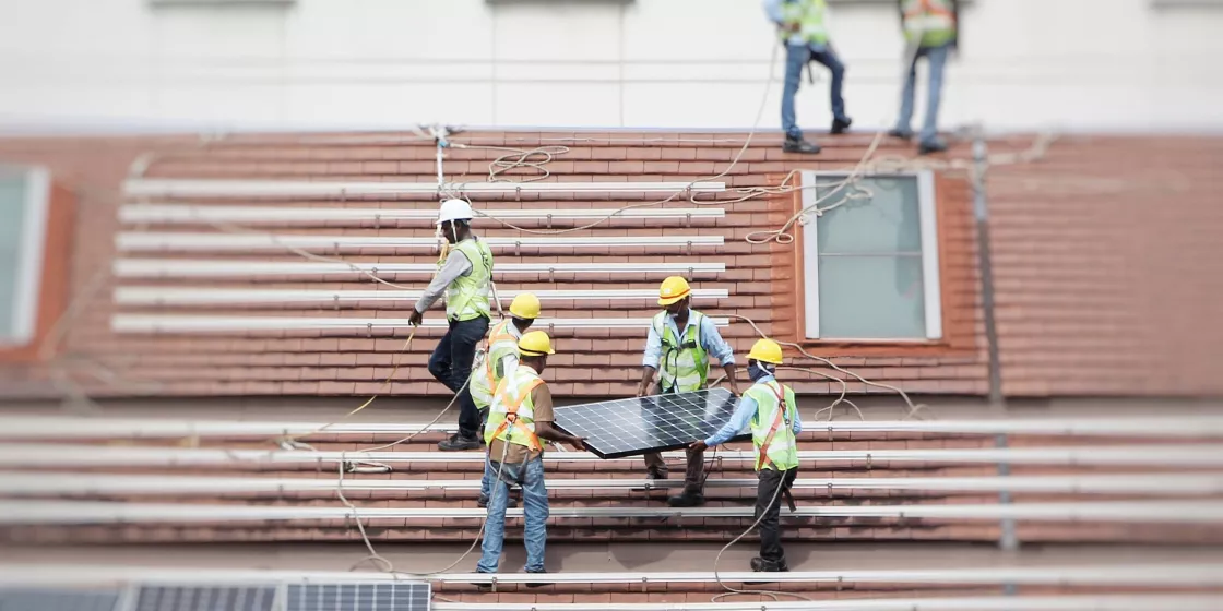 Workers installing solar panels