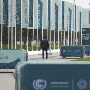 A member of security walks outside the venue for the COP29